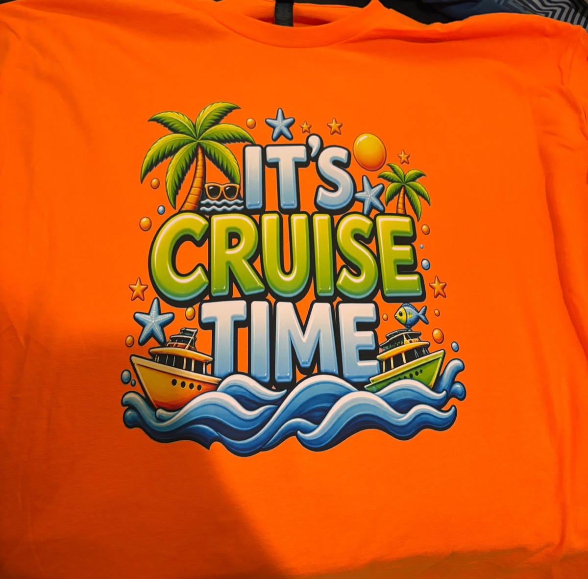 Orange tee with a bright It's Cruise Time print