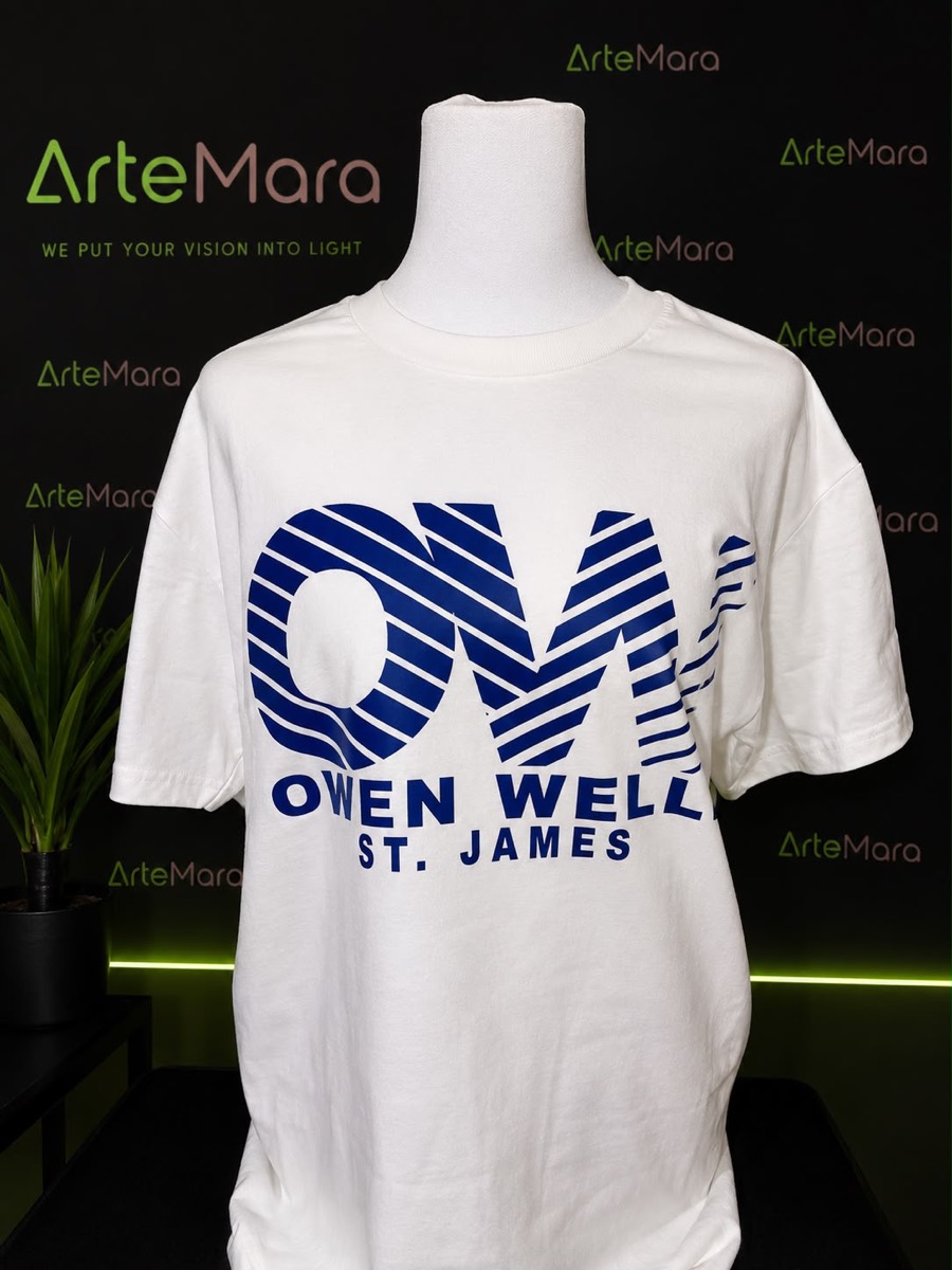 White tee with a striped navy OM monogram for Owen Wells, St. James